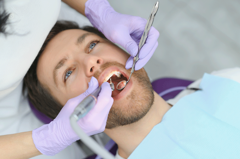 Closeup Shot Of Smiling Man Getting Treatment